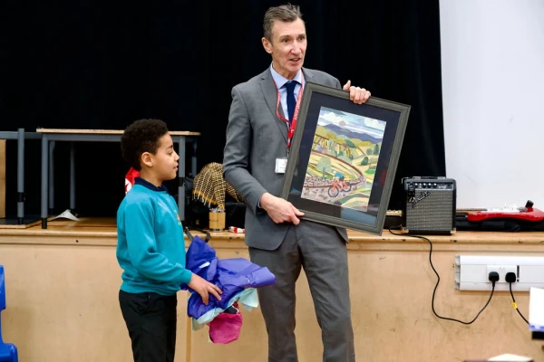 Oatlands Junior School pupil presents Richard Sheriff with gift