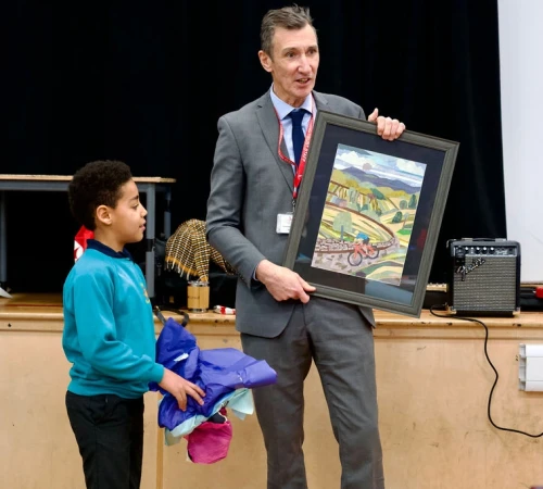 Oatlands Junior School pupil presents Richard Sheriff with gift