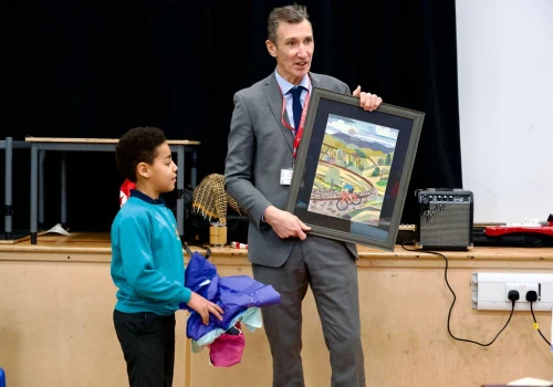 Oatlands Junior School pupil presents Richard Sheriff with gift