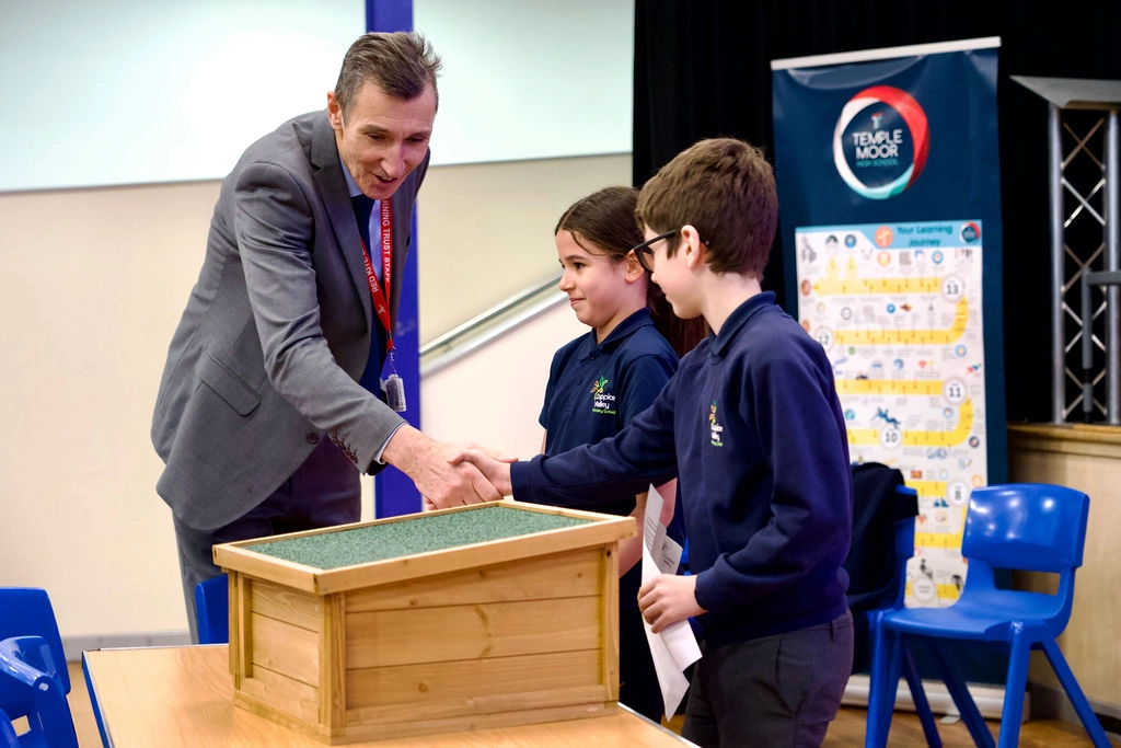 Coppice Valley pupils present gift of hedgehog hut to Richard Sheriff